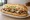 Cheesesteak Hoagie: an illustration of beef, provolone, mayonnaise, lettuce and more on hoagie roll.