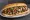 Cheesesteak Supreme: an illustration of beef, provolone, onion, pepper and more on hoagie roll.