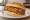 Chicago-Style Egg Roll: an illustration of beef, sprouts and mustard on burger bun.