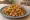 Chicken Kothu Parotta: an illustration of chicken, egg, onion and pepper.