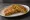 Chicken Paratha: an illustration of chicken, onion, ginger, garlic and more on naan.