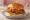 Chicken Sandwich Wars Entry: an illustration of chicken, pickle and mayonnaise on burger bun.