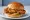 Chicken Sandwich Wars (Global Impact): an illustration of chicken, pickle and mayonnaise on burger bun.