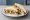 Chicken Tikka and Raita: an illustration of chicken, yogurt, cucumber and mint on white bread.
