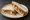 Chicken Tikka Sandwich: an illustration of chicken, chutney, onion and cilantro on white bread.