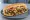 Chopped Cheese with Hot Peppers: an illustration of beef, american cheese, jalapeño, lettuce and more on hoagie roll.