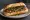 Choripán: an illustration of pork, beef, sausage, chimichurri and more on baguette.