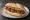 Choripán con Mostaza: an illustration of pork, sausage and mustard on baguette.
