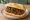 Chorizo Bomba: an illustration of pork, sausage and chimichurri on baguette.