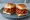 Chorizo Pao: an illustration of pork, sausage, garlic, pepper and more on bread.