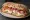 Ciabatta con Prosciutto e Mozzarella: an illustration of prosciutto, mozzarella and olive oil on ciabatta.