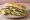 Çinekop Ekmek: an illustration of onion, lettuce and lemon on bread.