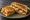 Club Sandwich Tosti: an illustration of chicken, bacon, cheese, lettuce and more.
