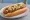 Coney Island Hot Dog (Original): an illustration of beef, pepper, onion and mustard on hot dog bun.