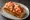Connecticut Lobster Roll: an illustration of lobster and butter on hot dog bun.