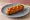 Corn Dog: an illustration of beef, mustard and ketchup.
