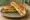 Corn Sandwich: an illustration of corn, cheese and butter on white bread.