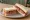 Corned Beef and Pickle: an illustration of corned beef, pickle and butter on white bread.