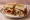 Corned Beef Hash Sandwich: an illustration of corned beef, potato, onion and butter on white bread.