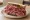 Corned Beef Sandwich (Cleveland): an illustration of corned beef and mustard on rye bread.