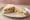 Coronation Chicken: an illustration of chicken, mayonnaise, curry powder, chutney and more on white bread.
