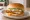 Crispy Fish Sandwich: an illustration of fish, tartar sauce, american cheese and lettuce on burger bun.