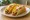 Crispy Taco (Ground Beef): an illustration of beef, cheddar cheese, lettuce and tomato on tortilla.