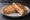 Croque-Mademoiselle: an illustration of ham, gruyère and butter on white bread.