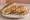 Croqueta Preparada: an illustration of ham, pork, swiss cheese, lettuce and more on cuban bread.