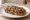 Crostino Toscano: an illustration of caper, anchovy, onion and olive oil.