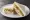 CU — Chicken Breast Sandwich: an illustration of chicken, lettuce, tomato and mayonnaise on white bread.