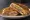 Cuban Sandwich (Tampa): an illustration of ham, pork, salami, swiss cheese and more on cuban bread.