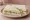 Cucumber and Cream Cheese: an illustration of cream cheese and cucumber on white bread.