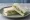Cucumber and Dill: an illustration of cream cheese, cucumber, dill and butter on white bread.