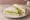 Cucumber with Lemon Butter: an illustration of butter, cucumber and lemon on white bread.
