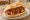 Currywurst im Brötchen: an illustration of ketchup, curry powder and paprika on kaiser roll.