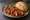 Currywurst mit Brötchen: an illustration of ketchup and curry powder on kaiser roll.