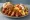 Currywurst Pommes: an illustration of ketchup, curry powder, mayonnaise and potato on bread.