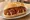 Currywurst scharf: an illustration of ketchup, curry powder and pepper on bread.