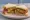 Cutlet Sandwich: an illustration of chutney, onion, tomato and cucumber on white bread.