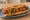 Danger Dog: an illustration of beef, bacon, mayonnaise, ketchup and more on hot dog bun.