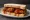 DC Mumbo Sauce Wings Sandwich: an illustration of chicken on white bread.