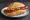 Debreziner: an illustration of sausage, mustard and paprika on bread.