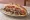 Döner Ekmek: an illustration of beef, chicken, tomato, onion and more on bread.