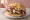Döner im Brot: an illustration of beef, chicken, lettuce, tomato and more on bread.