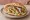 Döner mit Halloumi: an illustration of halloumi, lettuce, tomato, onion and more.