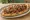 Döner Pide: an illustration of beef, chicken, tomato, onion and more on pita.