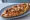 Dönerli Pide: an illustration of beef, chicken, cheese and tomato on pita.
