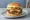 Doppel-Burger: an illustration of beef, cheese, lettuce, tomato and more on burger bun.