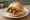 Drei im Weggla: an illustration of pork, sausage and mustard on bread.